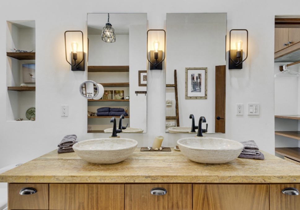 Double vanity bathroom with stone vessel sinks and elegant fixtures