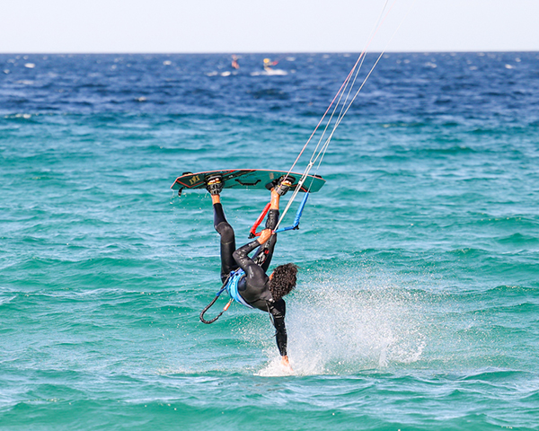 Kitesurfer riding turquoise waves off the coast of Los Barriles